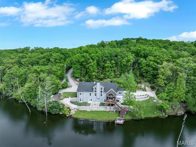 view from above of property featuring a forest and a large body of water