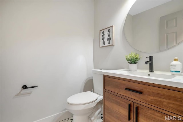 half bathroom featuring toilet and vanity