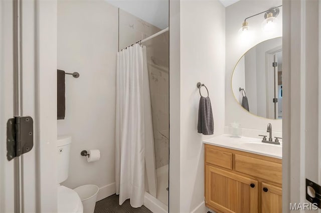 full bathroom with a shower stall, toilet, vanity, and baseboards