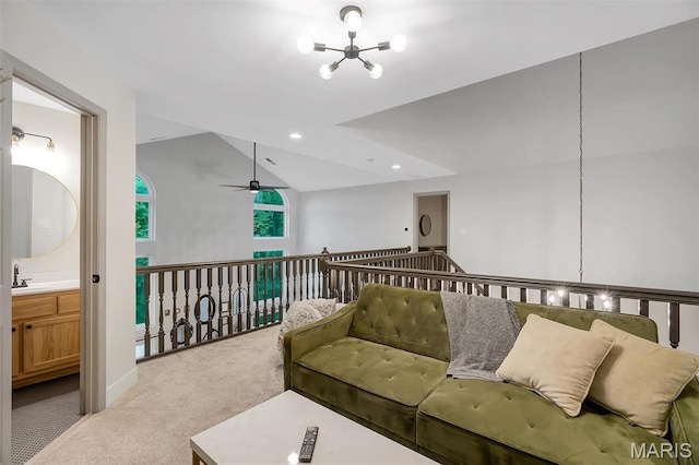 carpeted living room featuring a chandelier, lofted ceiling, a sink, ceiling fan, and recessed lighting