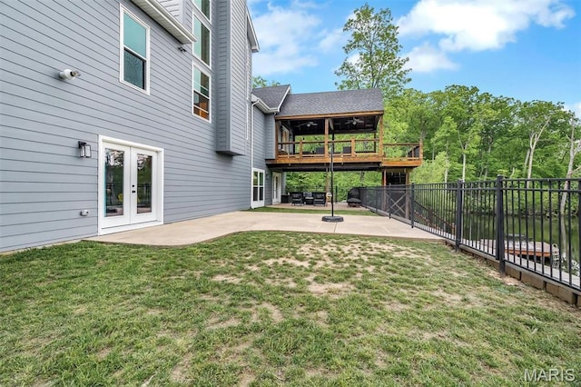 view of yard with a patio area, french doors, and a deck