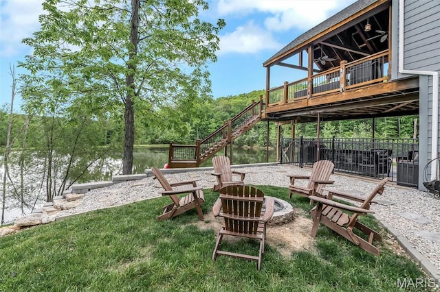 view of yard featuring an outdoor fire pit, stairway, and a wooden deck