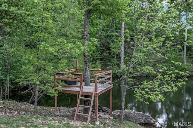 dock featuring a wooded view and a water view