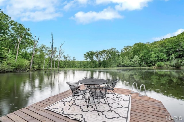 dock area with a view of trees and a water view