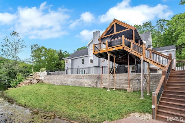 back of property featuring stairs, a deck, and a chimney