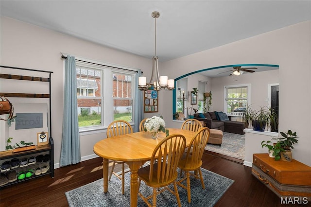 6211 Odell St, Saint Louis, MO 63139 - dining area with a chandelier, a ceiling fan, baseboards, wood finished floors, and arched walkways