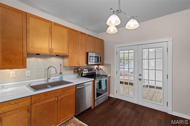 6211 Odell St, Saint Louis, MO 63139 - kitchen with appliances with stainless steel finishes, a sink, french doors, dark wood-style floors, and light countertops