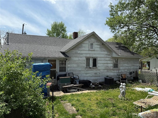 108 Hampton Ave, Park Hills, MO 63601 - rear view of house featuring roof with shingles, a chimney, and cooling unit