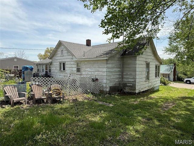 108 Hampton Ave, Park Hills, MO 63601 - rear view of property with a yard, a chimney, and roof with shingles