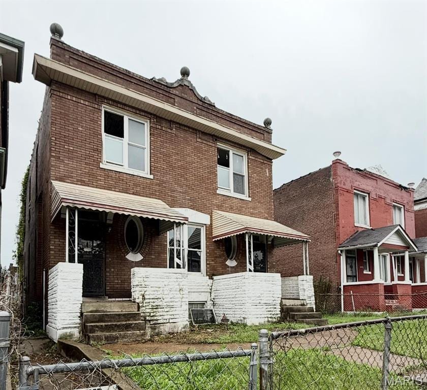 3930 Sullivan Ave, Saint Louis, MO 63107 - rear view of house with brick siding and covered porch