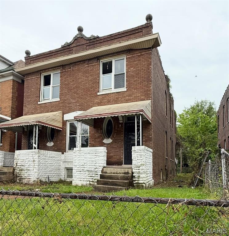 3930 Sullivan Ave, Saint Louis, MO 63107 - back of house featuring brick siding and covered porch