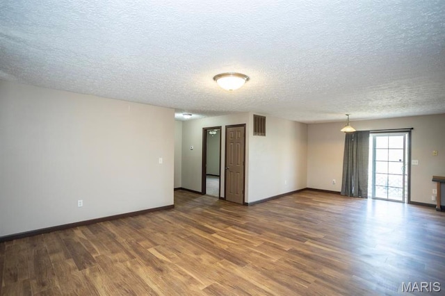 15625 Talon Ln, Saint Robert, MO 65584 - empty room featuring wood finished floors, a textured ceiling, and baseboards