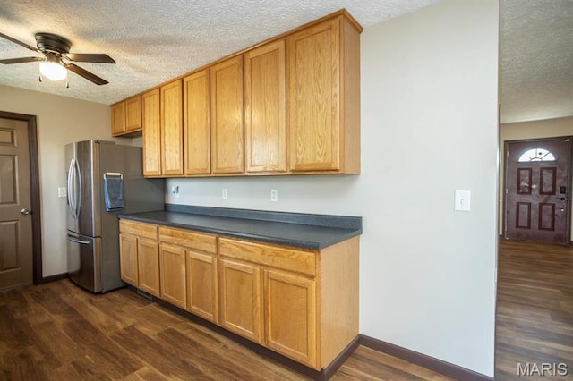 15625 Talon Ln, Saint Robert, MO 65584 - kitchen with stainless steel fridge with ice dispenser, a textured ceiling, dark countertops, a ceiling fan, and dark wood-type flooring