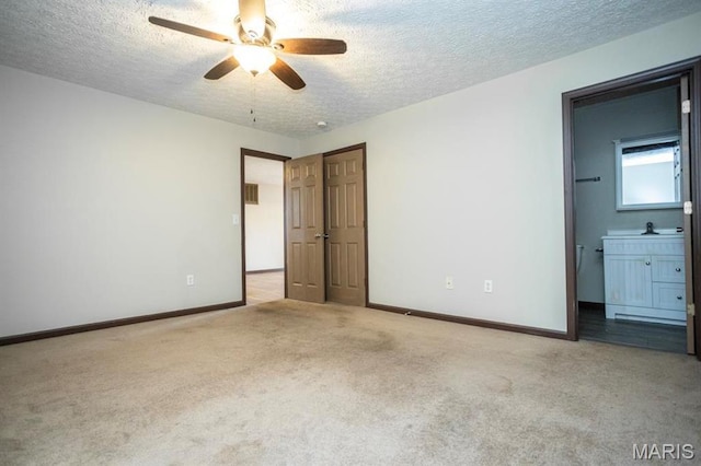 15625 Talon Ln, Saint Robert, MO 65584 - unfurnished bedroom featuring carpet flooring, a textured ceiling, baseboards, and ensuite bath