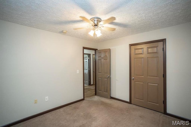 15625 Talon Ln, Saint Robert, MO 65584 - unfurnished bedroom featuring light colored carpet, baseboards, a textured ceiling, and ceiling fan