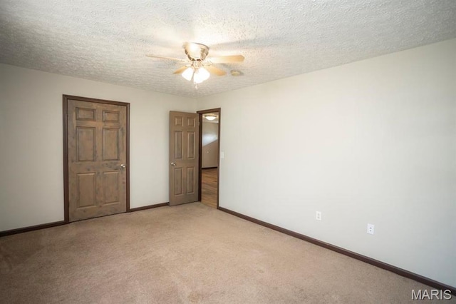 15625 Talon Ln, Saint Robert, MO 65584 - unfurnished bedroom with baseboards, light carpet, a textured ceiling, and a ceiling fan