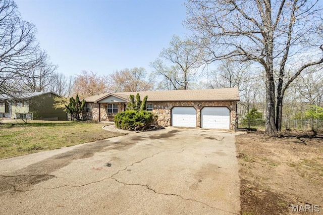 15625 Talon Ln, Saint Robert, MO 65584 - view of front of house with asphalt driveway, stone siding, and a garage