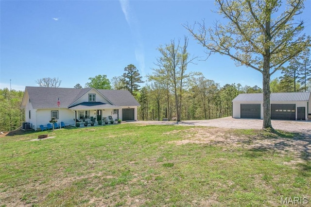 176 Carter 205, Van Buren, MO 63965 - view of green lawn with a garage, an outbuilding, cooling unit, and covered porch