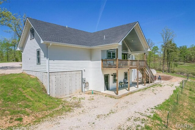 176 Carter 205, Van Buren, MO 63965 - back of house featuring a patio, a deck, a shingled roof, stairs, and a lawn