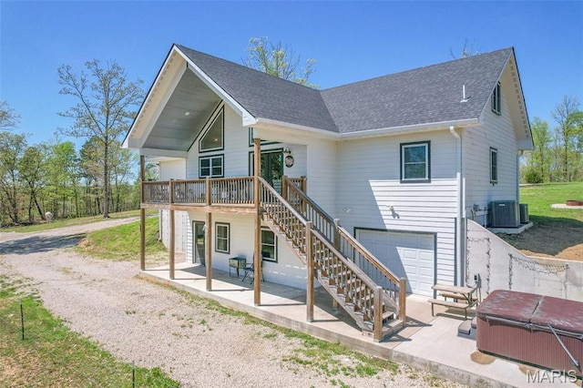 176 Carter 205, Van Buren, MO 63965 - rear view of house with stairs, a patio area, a garage, a hot tub, and a wooden deck