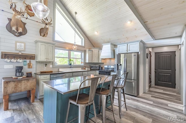 176 Carter 205, Van Buren, MO 63965 - kitchen with stainless steel appliances, a sink, light wood-style floors, a kitchen bar, and wooden ceiling