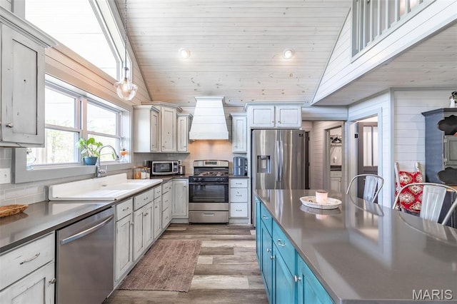 176 Carter 205, Van Buren, MO 63965 - kitchen with stainless steel appliances, custom exhaust hood, light wood-type flooring, a sink, and wooden ceiling