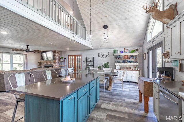 176 Carter 205, Van Buren, MO 63965 - kitchen featuring blue cabinets, stainless steel dishwasher, open floor plan, high vaulted ceiling, and a ceiling fan