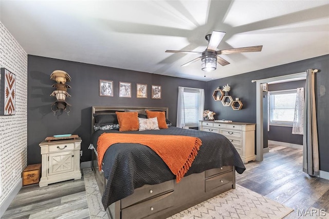 176 Carter 205, Van Buren, MO 63965 - bedroom with an accent wall, multiple windows, wood finished floors, and brick wall