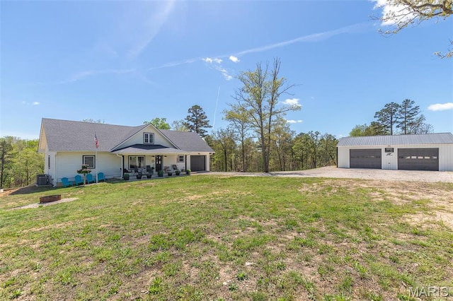 176 Carter 205, Van Buren, MO 63965 - view of grassy yard featuring central AC, a detached garage, driveway, and an outbuilding