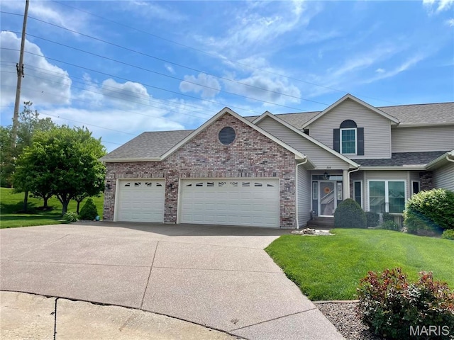 235 River Bluff Ct, Troy, MO 63379 - view of front of house with an attached garage, concrete driveway, a front yard, brick siding, and a shingled roof