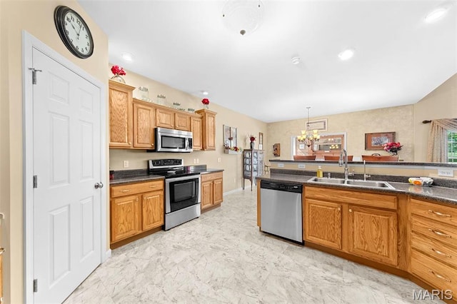 235 River Bluff Ct, Troy, MO 63379 - kitchen featuring appliances with stainless steel finishes, a sink, dark countertops, and a chandelier