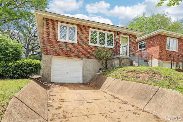 4116 Parker Ave, Saint Louis, MO 63116 - view of front of home featuring brick siding, concrete driveway, and an attached garage