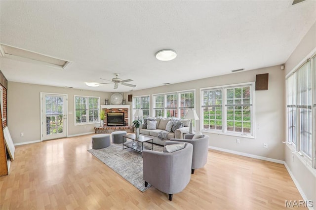 4116 Parker Ave, Saint Louis, MO 63116 - living room featuring wood finished floors, plenty of natural light, ceiling fan, baseboards, and a textured ceiling