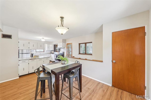 4116 Parker Ave, Saint Louis, MO 63116 - dining room with baseboards and light wood-style floors