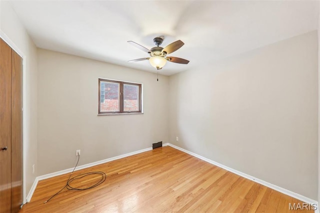 4116 Parker Ave, Saint Louis, MO 63116 - unfurnished bedroom featuring a closet, baseboards, light wood-style floors, and a ceiling fan