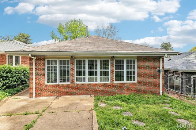 4116 Parker Ave, Saint Louis, MO 63116 - back of property with brick siding, fence, and roof with shingles