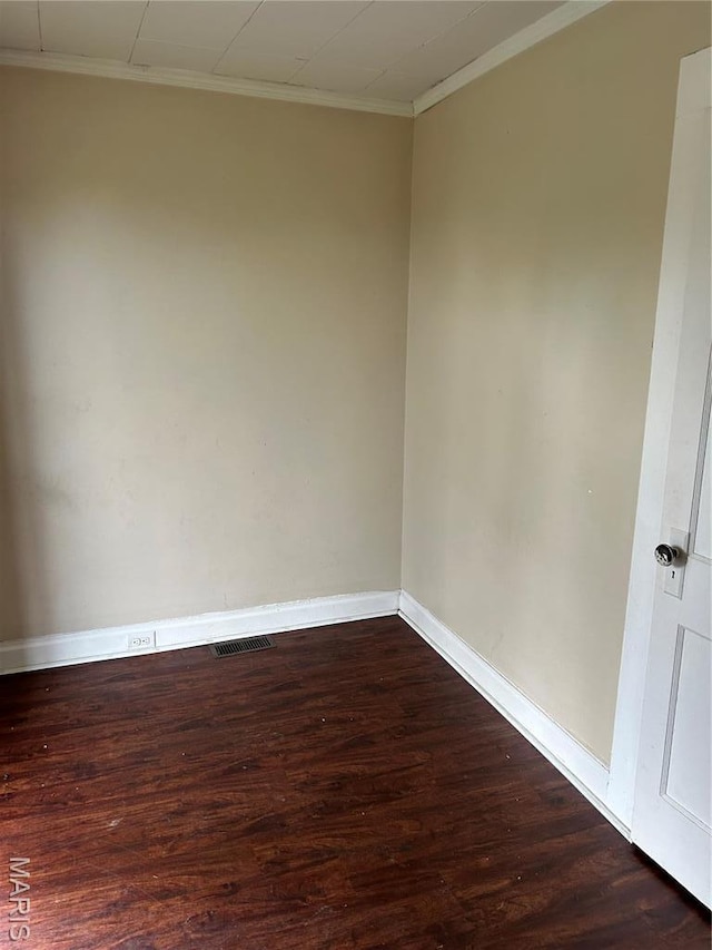 122 Fermo Ave, Ferguson, MO 63135 - unfurnished room featuring dark wood-style flooring, ornamental molding, and baseboards