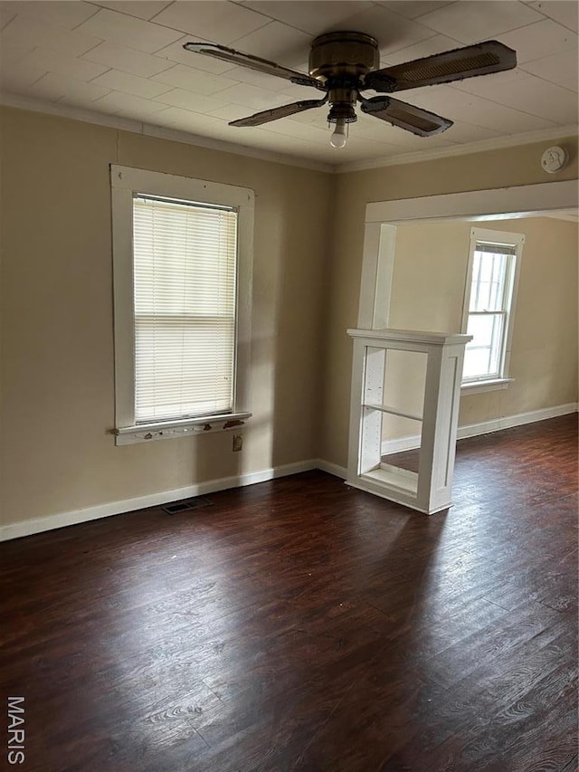 122 Fermo Ave, Ferguson, MO 63135 - unfurnished room featuring crown molding, dark wood-style floors, ceiling fan, and baseboards