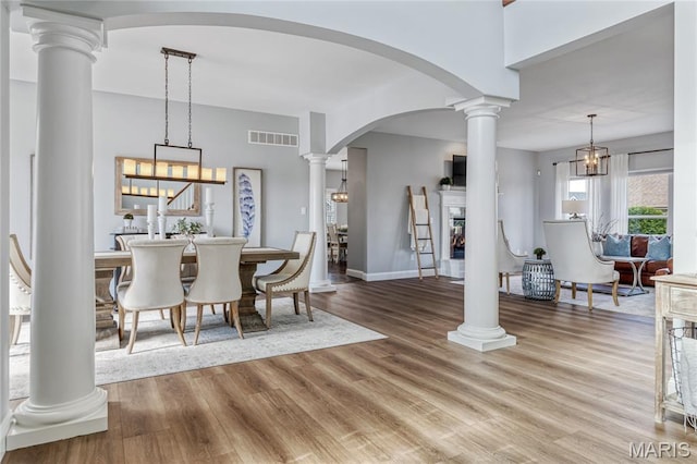 2 Pearview Ct, Saint Peters, MO 63376 - dining area with wood finished floors, baseboards, arched walkways, and a glass covered fireplace