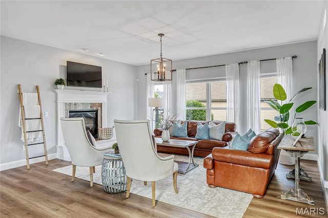 2 Pearview Ct, Saint Peters, MO 63376 - living room featuring wood finished floors, a fireplace, a chandelier, and baseboards