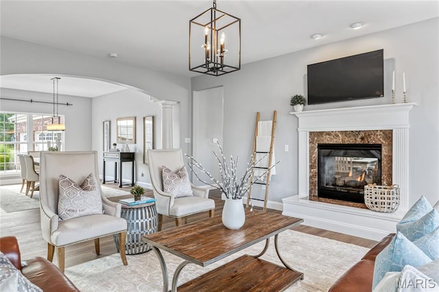 2 Pearview Ct, Saint Peters, MO 63376 - living room featuring wood finished floors, arched walkways, plenty of natural light, and a chandelier