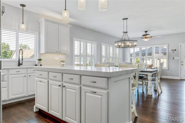 2 Pearview Ct, Saint Peters, MO 63376 - kitchen with dark wood-style flooring, ceiling fan, a center island, white cabinets, and hanging light fixtures