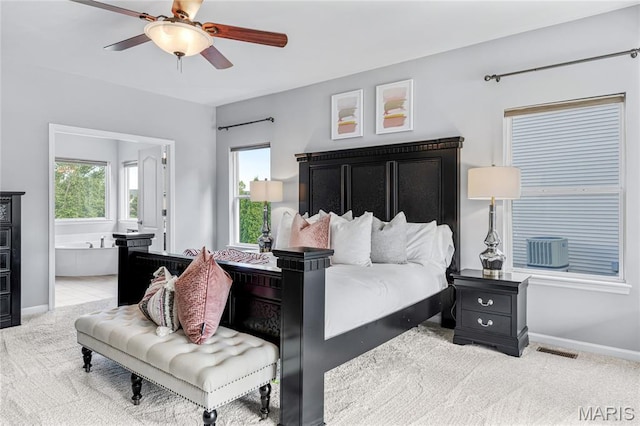 2 Pearview Ct, Saint Peters, MO 63376 - carpeted bedroom with multiple windows, connected bathroom, baseboards, and ceiling fan