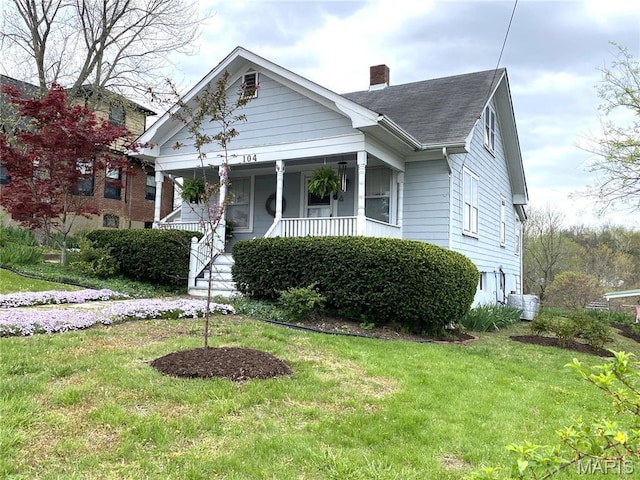104 E 12th St, Hermann, MO 65041 - bungalow-style house with a chimney, a front lawn, a porch, and roof with shingles