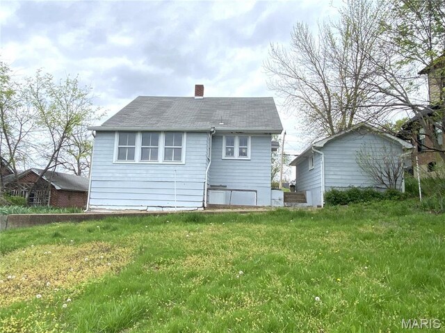 104 E 12th St, Hermann, MO 65041 - back of house featuring a chimney and a shingled roof