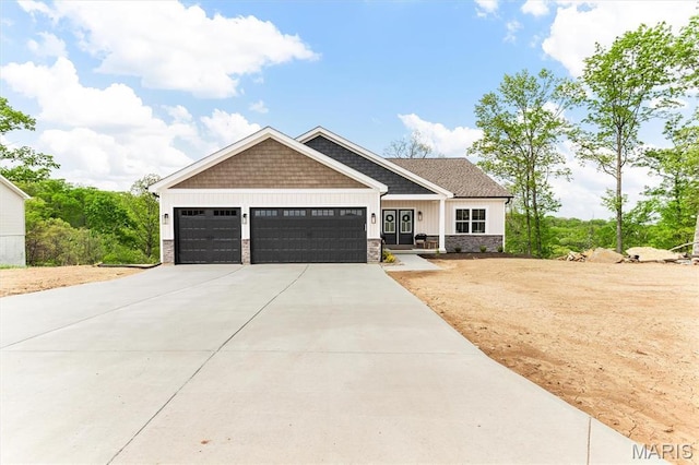 2217 Valleyview Dr, Barnhart, MO 63012 - craftsman-style house featuring an attached garage, driveway, stone siding, and board and batten siding
