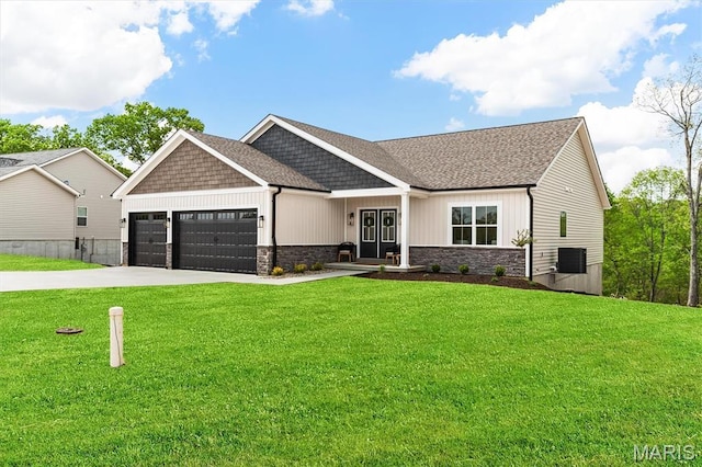 2217 Valleyview Dr, Barnhart, MO 63012 - view of front of property featuring an attached garage, driveway, stone siding, and a front lawn
