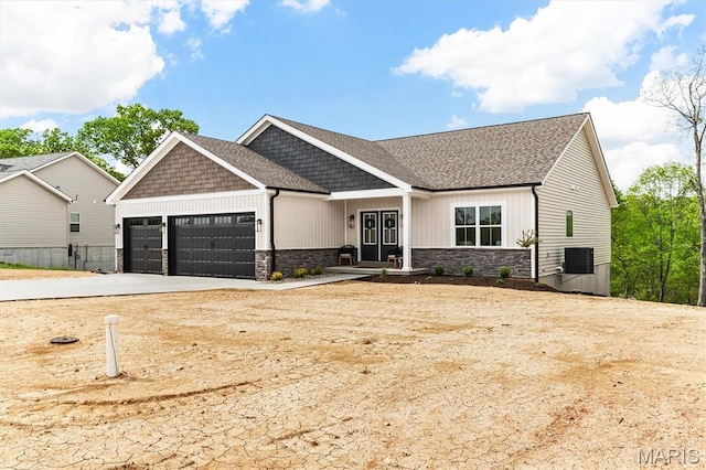 2217 Valleyview Dr, Barnhart, MO 63012 - view of front of house with an attached garage, stone siding, concrete driveway, board and batten siding, and roof with shingles