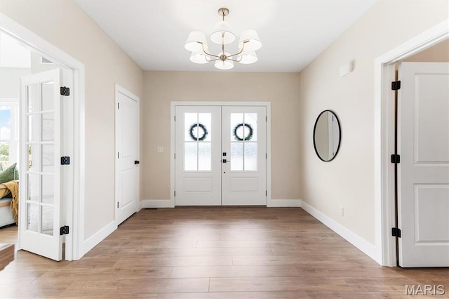 2217 Valleyview Dr, Barnhart, MO 63012 - foyer with french doors, a chandelier, light wood finished floors, and baseboards