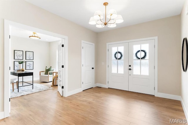 2217 Valleyview Dr, Barnhart, MO 63012 - foyer entrance with french doors, light wood finished floors, a chandelier, and baseboards